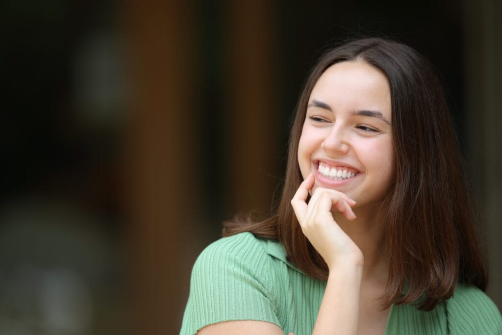Happy Young Woman with Natural Smile - Dentist in South Gate, CA A young woman beams with joy, reflecting the confidence that comes with excellent oral health. - Dentist in South Gate, CA