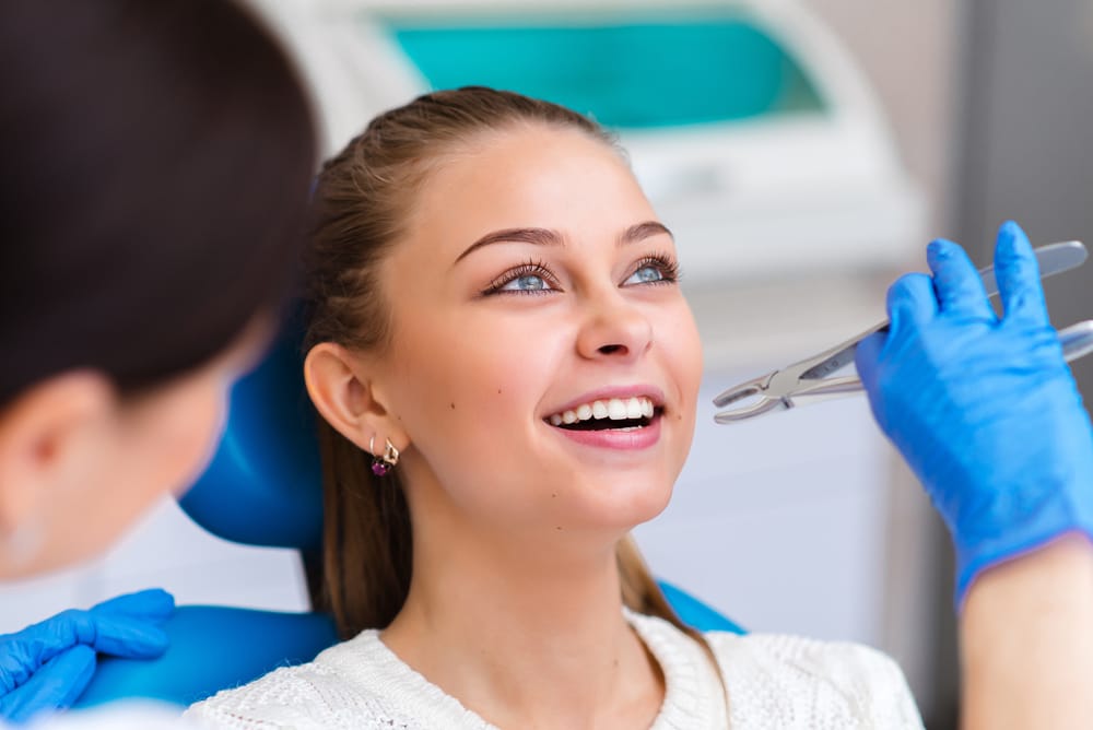 Young Woman at Dental Checkup - Dentist in South Gate, CA A happy patient enjoys her dental appointment, showing trust and comfort in professional oral care services. - Dentist in South Gate, CA